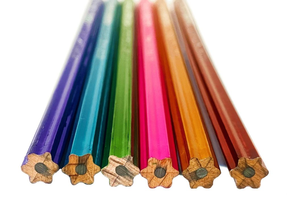 Assorted pastel HEXAGRAMU CRYSTAL pencils lined up, star-shaped cross section visible